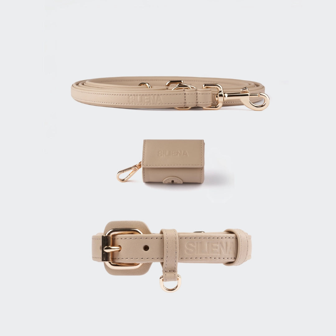 Hundeset in Beige bestehend aus Echtleder Halsband, verstellbarer Leine und Kotbeutelspender im gleichen Farbton.